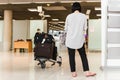 Woman toruist at the airport with trolley bag waiting for departure. Royalty Free Stock Photo