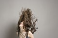 Woman Tossing Long Brown Wavy Hair