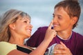 Woman touches with finger nose of smiling boy