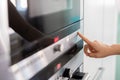 Woman Touching Control Panel On Electric Oven In Kicthen With Finger Royalty Free Stock Photo