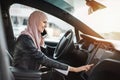 Woman touching dashboard while talking on mobile in car Royalty Free Stock Photo