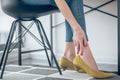 Woman touching her aching feet in a new shoe Royalty Free Stock Photo
