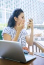 Woman touching her face while looking at mirror Royalty Free Stock Photo