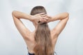 Woman touching her long hair, gathered her hair from the back of her head Royalty Free Stock Photo