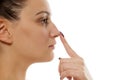 Woman touching her nose Royalty Free Stock Photo