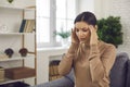 Woman touching her temples, suffering from stress, bad headache or severe migraine Royalty Free Stock Photo