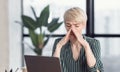 Woman Touching Nosebridge Having Sinus Pain Sitting At Workplace Indoors Royalty Free Stock Photo