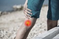 Woman touching painful varicose veins on a leg with red dot effect