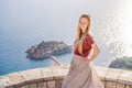 Woman tourist on background of beautiful view of the island of St. Stephen, Sveti Stefan on the Budva Riviera, Budva Royalty Free Stock Photo