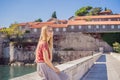 Woman tourist on background of beautiful view of the island of St. Stephen, Sveti Stefan on the Budva Riviera, Budva Royalty Free Stock Photo
