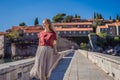 Woman tourist on background of beautiful view of the island of St. Stephen, Sveti Stefan on the Budva Riviera, Budva Royalty Free Stock Photo