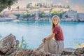 Woman tourist on background of beautiful view of the island of St. Stephen, Sveti Stefan on the Budva Riviera, Budva Royalty Free Stock Photo