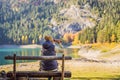 Woman tourist in background of Panoramic morning view of Black Lake Crno Jezero. Calm summer scene of Durmitor Royalty Free Stock Photo