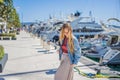 Woman tourist on background of Yacht marina, beautiful Mediterranean landscape in warm colors. Montenegro, Kotor Bay Royalty Free Stock Photo