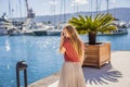 Woman tourist on background of Yacht marina, beautiful Mediterranean landscape in warm colors. Montenegro, Kotor Bay Royalty Free Stock Photo