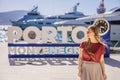 Woman tourist on background of Yacht marina, beautiful Mediterranean landscape in warm colors. Montenegro, Kotor Bay Royalty Free Stock Photo