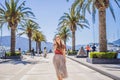 Woman tourist on background of Yacht marina, beautiful Mediterranean landscape in warm colors. Montenegro, Kotor Bay Royalty Free Stock Photo