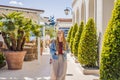 Woman tourist on background of Yacht marina, beautiful Mediterranean landscape in warm colors. Montenegro, Kotor Bay Royalty Free Stock Photo