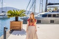 Woman tourist on background of Yacht marina, beautiful Mediterranean landscape in warm colors. Montenegro, Kotor Bay Royalty Free Stock Photo