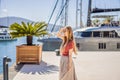 Woman tourist on background of Yacht marina, beautiful Mediterranean landscape in warm colors. Montenegro, Kotor Bay Royalty Free Stock Photo