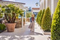 Woman tourist on background of Yacht marina, beautiful Mediterranean landscape in warm colors. Montenegro, Kotor Bay Royalty Free Stock Photo