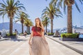 Woman tourist on background of Yacht marina, beautiful Mediterranean landscape in warm colors. Montenegro, Kotor Bay Royalty Free Stock Photo