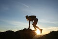 Woman tourist with backpack in tourist clothes climbs mountain