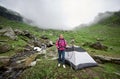 Woman tourist near tent in valley of Romanian mountains Royalty Free Stock Photo
