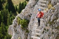 Woman tourist crosses a via ferrata suspended bridge at Lacul Rosu, Neamt county, Romania. Royalty Free Stock Photo