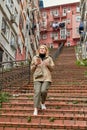Woman tourist descends the red stairs in Istanbul