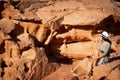 Woman tourist in dress sit on cliff at viewpoint on sunset in Wadi Rum desert - valley Wadi Saabit. Jordan explore concept Royalty Free Stock Photo