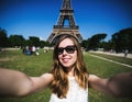 Woman tourist at Eiffel Tower smiling and making Royalty Free Stock Photo