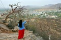 Woman tourist enjoying bird eye view of Pushkar lake or Pushkar Sarovar at Pushkar - Rajasthan - India