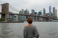 Woman tourist enjoying view of Brooklyn Bridge and Manhattan skyscrapers Royalty Free Stock Photo