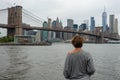 Woman tourist enjoying view of Brooklyn Bridge and Manhattan skyscrapers Royalty Free Stock Photo