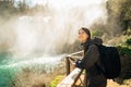 Woman tourist hiker visiting a mountain national park waterfall trail.Adventure tourist exploring nature.Nature and environment