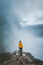 Woman tourist hiking alone in foggy mountains Norway, girl enjoying misty view adventure vacations Royalty Free Stock Photo