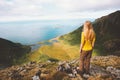 Woman tourist hiking alone on mountain summit cliff