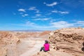 Woman tourist hiking in Atacama desert savanna, mountains and volcano landscape, Chile, South America