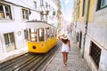 Woman tourist in Lisbon near yellow tram. Tourist attraction. Vacation, travel Royalty Free Stock Photo