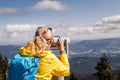 Woman tourist looking through coin operated binoculars at mountains Royalty Free Stock Photo