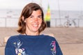 Woman tourist looks out terrace cafe beach ocean and ships Royalty Free Stock Photo