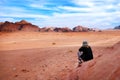 Woman tourist looks at the wonderful landscape view of Wadi Rum Jordan