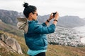 Woman tourist making photographs on mobile phone while hiking Royalty Free Stock Photo
