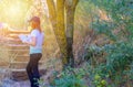 Woman tourist with map and hat standing in amazing forest, freedom and active lifstyle. Royalty Free Stock Photo