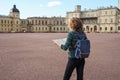 Woman tourist with map on the street. Travel guide, tourism in Europe. The ancient city of Gatchina. Royalty Free Stock Photo