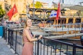 Woman tourist in Old town Kaleici in Antalya. Turkiye. Panoramic view of Antalya Old Town port, Taurus mountains and Royalty Free Stock Photo