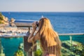 Woman tourist in Old town Kaleici in Antalya. Turkiye. Panoramic view of Antalya Old Town port, Taurus mountains and Royalty Free Stock Photo