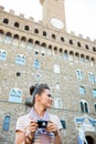 Woman tourist with photo camera looking aside. Florence, Italy Royalty Free Stock Photo