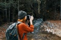 woman tourist photographing nature river forest mountains Royalty Free Stock Photo